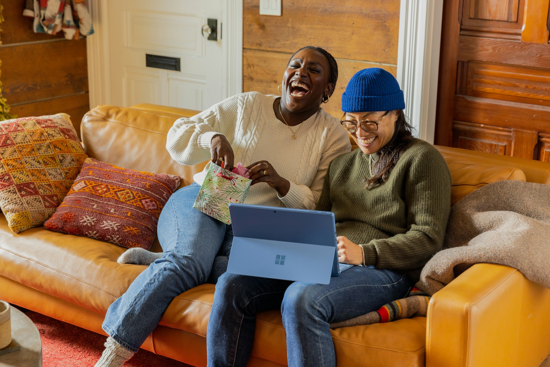two people looking at a tablet and smiling