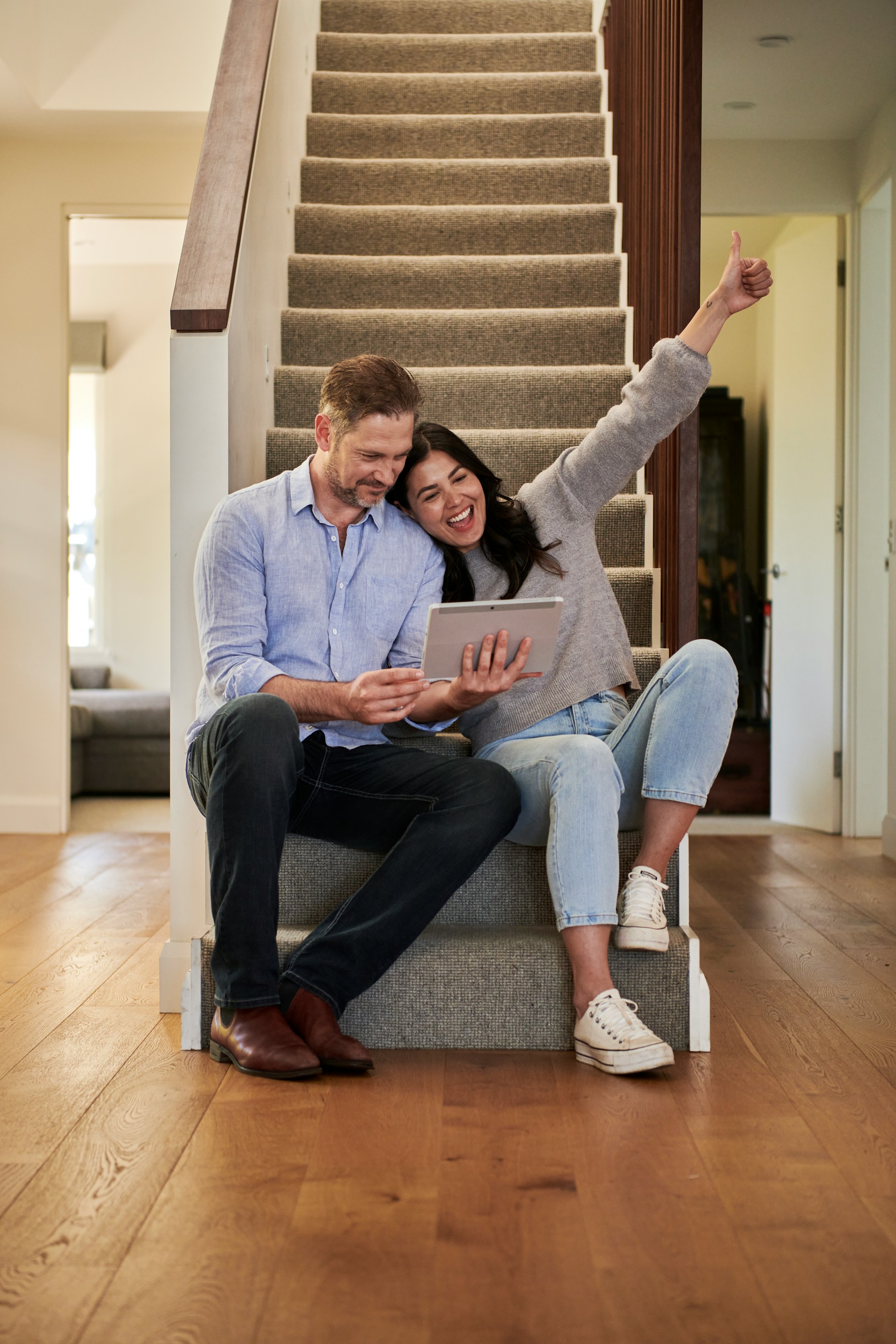 husband and wife working happily on a laptop